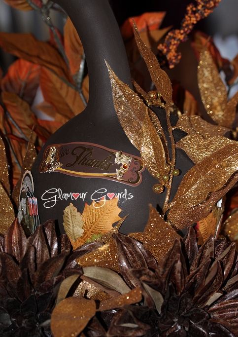 Wrapping a section of gold leaf garland up the side of the gourd.